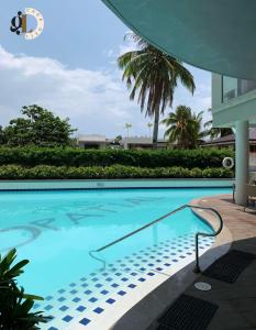 a swimming pool in a building with a palm tree at Minimalist Condo One Spatial Iloilo 2 Bedroom Unit in Iloilo City