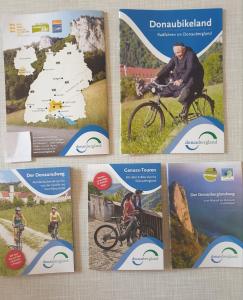 a collage of brochures with a man riding a bike at Ferienwohnung Varli in Tuttlingen +11 photos
