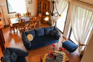 a living room with a blue couch and a table at Nice house in Euboea in Politiká