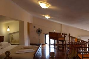 a bedroom with a bed and a piano in it at Nice house in Euboea in Politiká