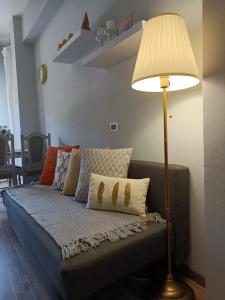 a bedroom with a couch with a lamp on it at Decò & Retrò apartment in La Spezia