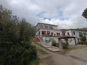 a large white house with a gazebo at Villa La Pila Bilo in Marina di Campo