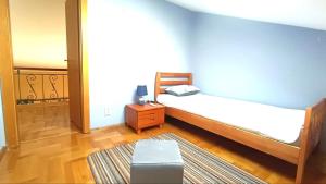 a bedroom with a bed and a table and a stool at Nossa Casa in Bečići