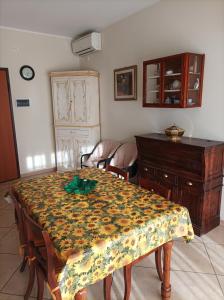 a dining room with a table and a dresser at Casa Betta in Certaldo