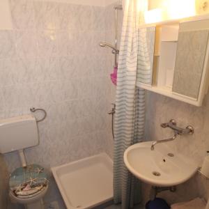 a bathroom with a sink and a toilet and a shower at Apartments Anita in Veli Lošinj