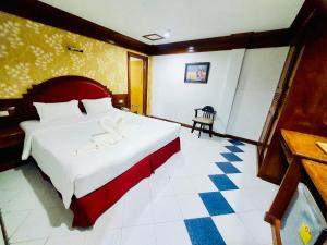 a bedroom with a large white bed in a room at Lime Hotel in Patong Beach