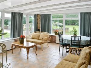 a living room with a table and chairs at Gamekeepers Cottage in Middleton