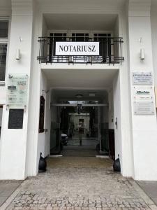 a entrance to a building with a sign on a balcony at Luxury Apartment In The City Center , Wi-Fi - by HIK Apartments in Warsaw