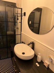 a bathroom with a sink and a mirror on a counter at Luxury Apartment In The City Center , Wi-Fi - by HIK Apartments in Warsaw +12 photos