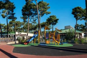a playground with a slide in a park at Mobilhome Eleganzia 713 Bonne Anse Plage in Les Mathes