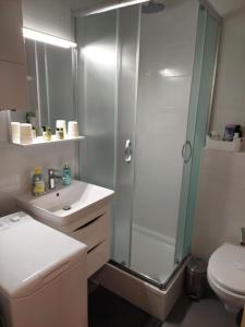 a bathroom with a shower and a sink and a toilet at New & Modern smart HOME, FREE parking in Zagreb