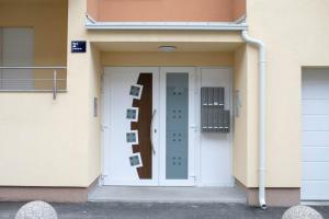 a white door of a building with pictures on it at New & Modern smart HOME, FREE parking in Zagreb