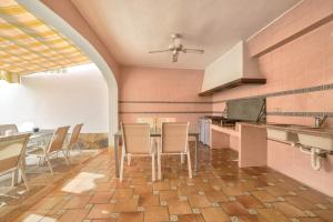 a kitchen with a table and chairs in a room at Villa Garrofer - PlusHolidays in Calpe
