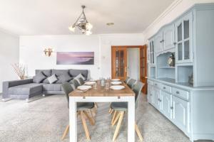 a kitchen and living room with a table and a couch at Villa Garrofer - PlusHolidays in Calpe +23 photos