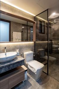 a bathroom with a toilet and a sink and a shower at Midtown Premium Phu My Hung in Ho Chi Minh City
