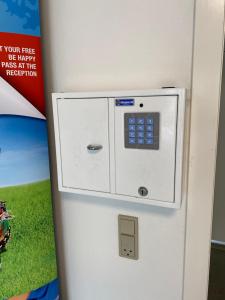 a refrigerator with a picture of a field on it at Grindsted - Billund Holiday Rooms in Grindsted