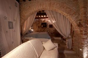 - un salon avec un canapé et un mur en briques dans l'établissement La Casina Del Lillotatini, à Panicale