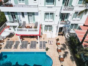an aerial view of a building with a swimming pool at H&ocirc;tel La Villa Juan Beach in Juan-les-Pins