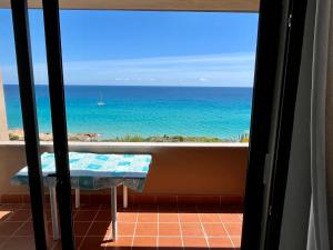 a view of the ocean from a balcony with a table at Casa Smeralda, Vista Mare Sea View in Fort Village