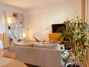 a living room with a couch and a tv at Appartement T3 Confluence in Lyon
