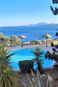 a swimming pool with a view of the water at Stefanosplace ApartHotel Sea View in Barbati