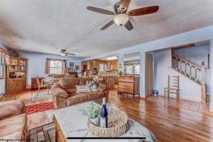 a living room with a couch and a ceiling fan at 3 Bedroom Cabin at Alpine Lake, near Deep Creek-WISP Resort in Terra Alta