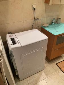 a washing machine sitting in a kitchen next to a sink at ZeusPlace House Marousso in Litochoro