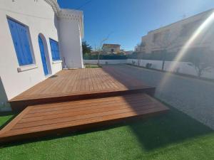 drewniany taras na boku budynku w obiekcie Maison chaleureuse 3 pièces à 60m de la plage avec jardin et terrasse barbecue - FR-1-326-772 w mieście Marseillan