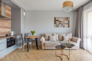 a living room with a couch and a table at Cubano - Mila Baltica in Gdańsk