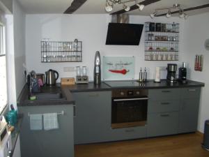 a kitchen with a sink and a counter top at Ferienwohnung RheinSpaziert in Dellhofen
