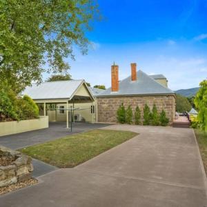 a brick house with a driveway in front of it at LUCAS Street in Kingston