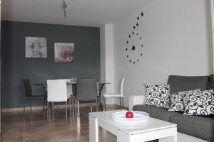 a living room with a couch and a table at Appartement tout confort, Rez-de chaussée,3 chambres, 2 salles de bain in Sant Jordi