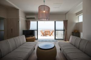 a living room with a couch and a table at BLUE MOON in Kawazu