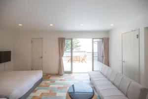 a living room with a couch and a table at BLUE MOON in Kawazu
