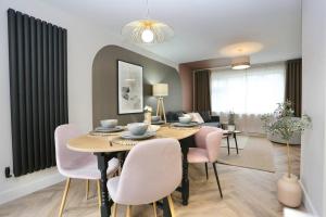 a dining room and living room with a table and chairs at xxBrand Newxx sleeps 8, stylish japandi house in Blackpool