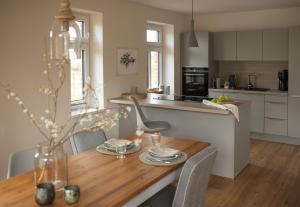 a kitchen and dining room with a wooden table and chairs at Haus 2 in Klenzau