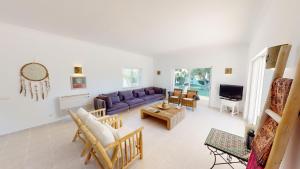 a living room with a couch and a table at Villa Sunset,sleeps 9,heatable pool,walk to marina in Vilamoura