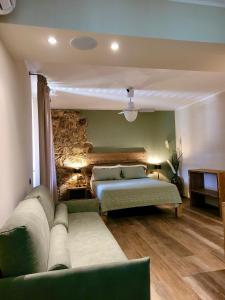 a living room with two beds and a couch at Agriturismo Montefabbrello in Magazzini