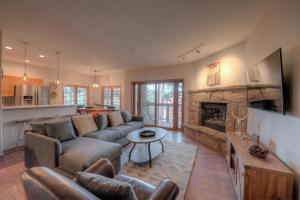 a living room with a couch and a fireplace at Los Pinos Columbine Condo Nice Updates Stroll to Lift in Breckenridge