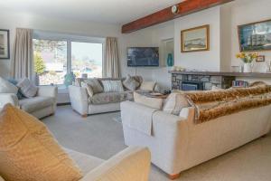 a large living room with couches and a fireplace at Compass Cottage in Abersoch