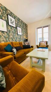 uma sala de estar com um sofá e uma mesa em Chez Brigitte em Bar-sur-Seine