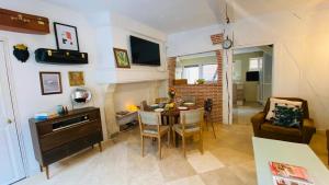 a living room with a table and a dining room at Chez Brigitte in Bar-sur-Seine
