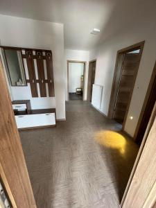 an empty room with a hallway with wooden floors at Apartmaji Seljak in Preddvor