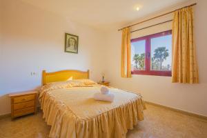 a bedroom with a large bed and a window at Villa Lina - PlusHolidays in Calpe