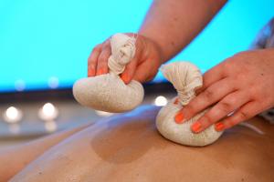 a person making mushrooms on a persons stomach at Hotel Dom Goncalo & Spa in Fátima