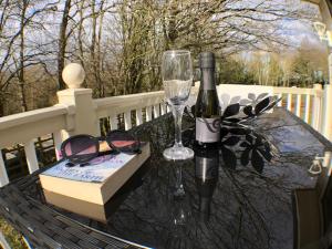 a table with a bottle of wine and a glass at Whitwell and Reepham Station - GEORGIE in Reepham