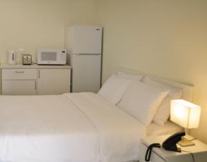 Postel nebo postele na pokoji v ubytování Riggae Tower Hotel