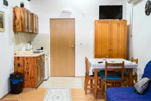 a kitchen with a table and a small kitchen with a table and chairs at Tri bagrema KM in Mokra Gora