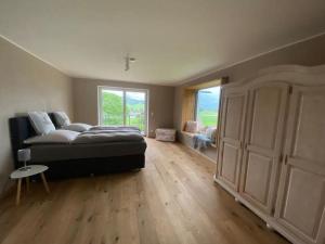 a large bedroom with a bed and a large window at Mountain View Lodge in Bergen