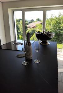 a table with two glasses and a bottle of wine at Mountain View Lodge in Bergen